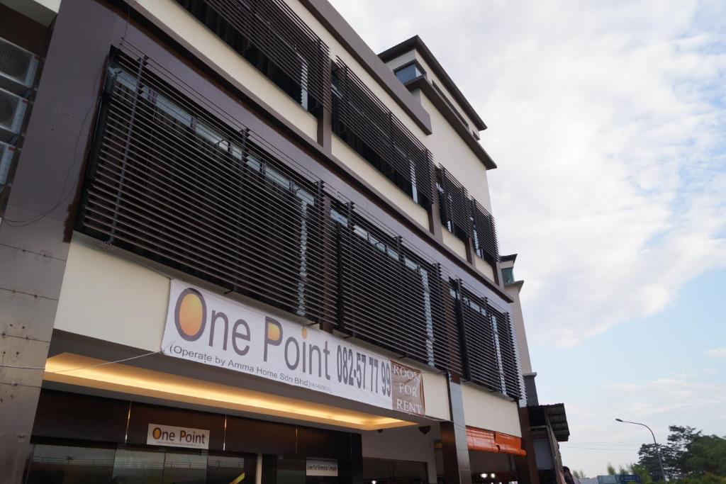 a building with a one point north sign on it at One Point Hotel in Kuching