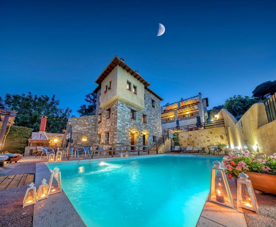 a large swimming pool in front of a building at Hotel Petradi in Kalamaki