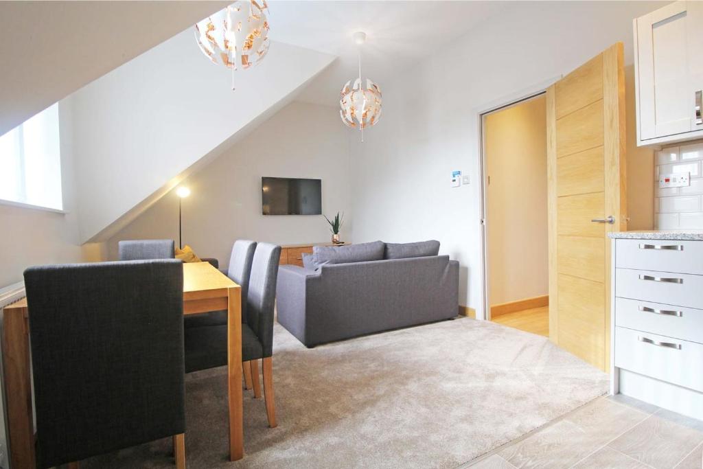 a living room with a dining room table and a kitchen at Hunters Walk - Luxury Central Chester Apartment - Free Parking in Chester