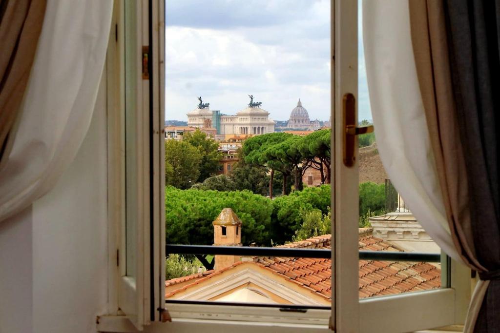 a window with a view of a city at Colosseo Sunset Apartment in Rome