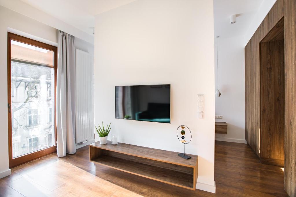 Televízia a/alebo spoločenská miestnosť v ubytovaní Homewell Apartments Dominikańska