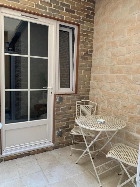 a patio with a table and chairs next to a door at Eiffel Tower studio with patio in Paris