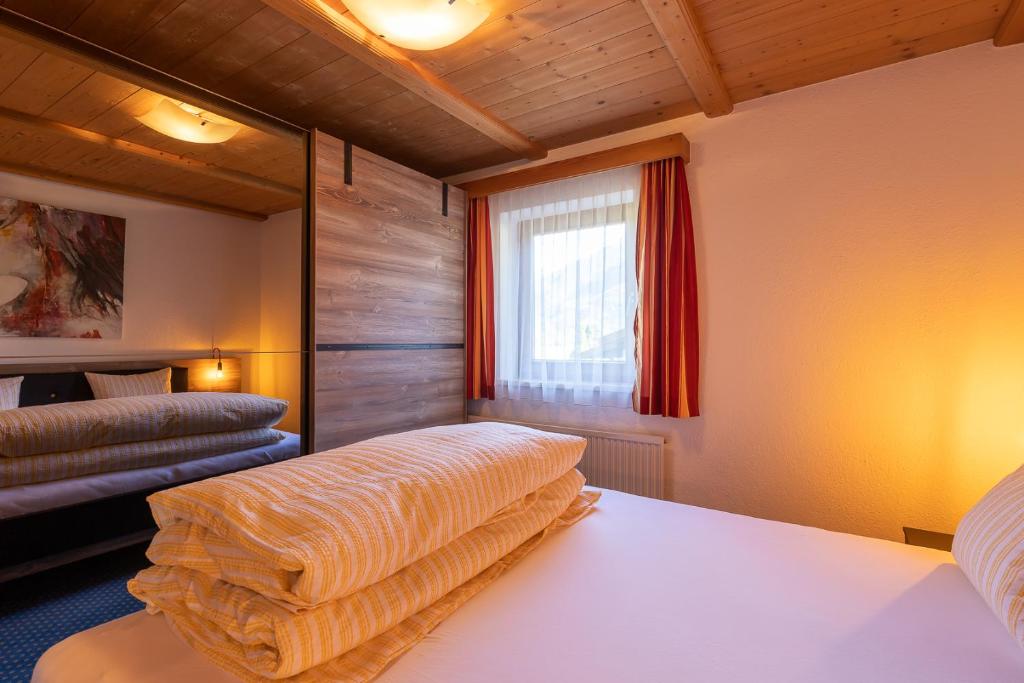 A bed or beds in a room at Haus Klaudia Gstrein