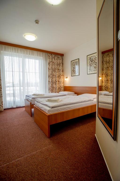 Postel nebo postele na pokoji v ubytování Wellness Hotel Thermal