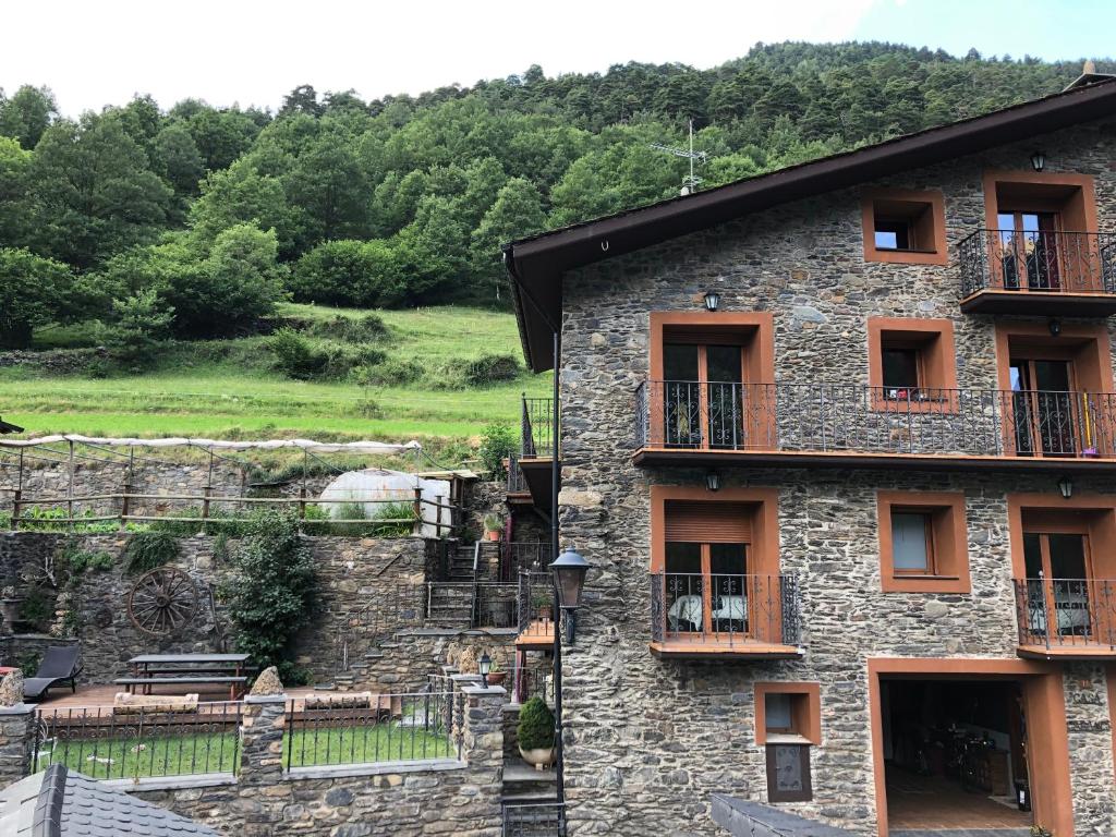 a stone building with balconies on the side of it at Casa Rustica Cabanes in Ordino