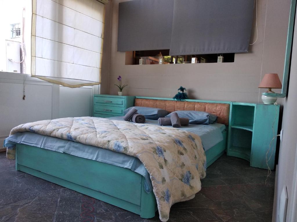 a bedroom with a bed and a blue cabinet at Alternative country house 10 minutes from Athens airport in Artemida