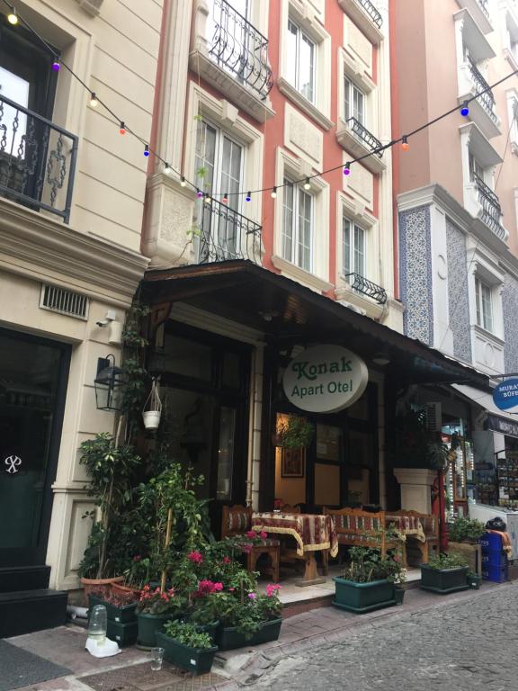 a building with a restaurant with plants in front of it at Konak Apart Hotel in Istanbul