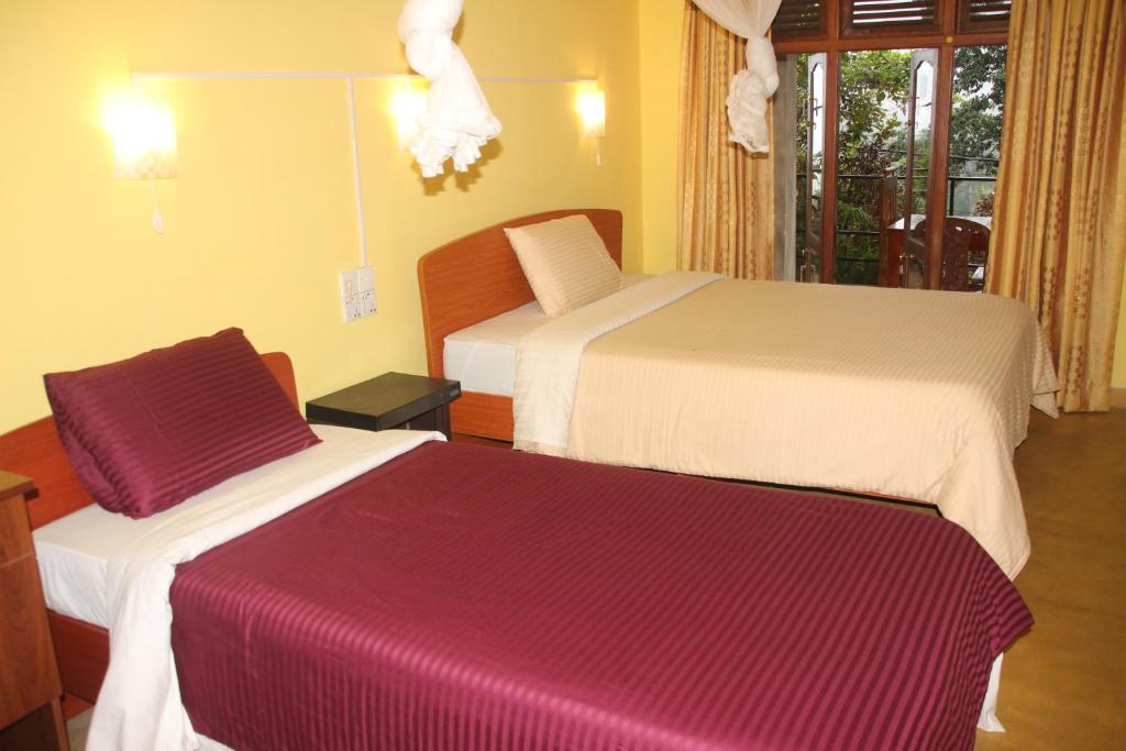 Postel nebo postele na pokoji v ubytování Welcome Inn