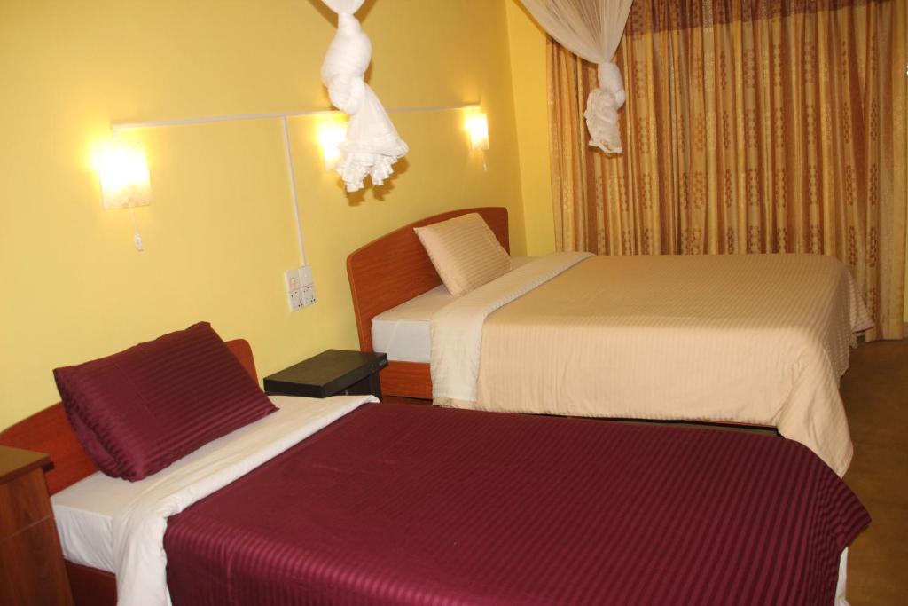 Postel nebo postele na pokoji v ubytování Welcome Inn