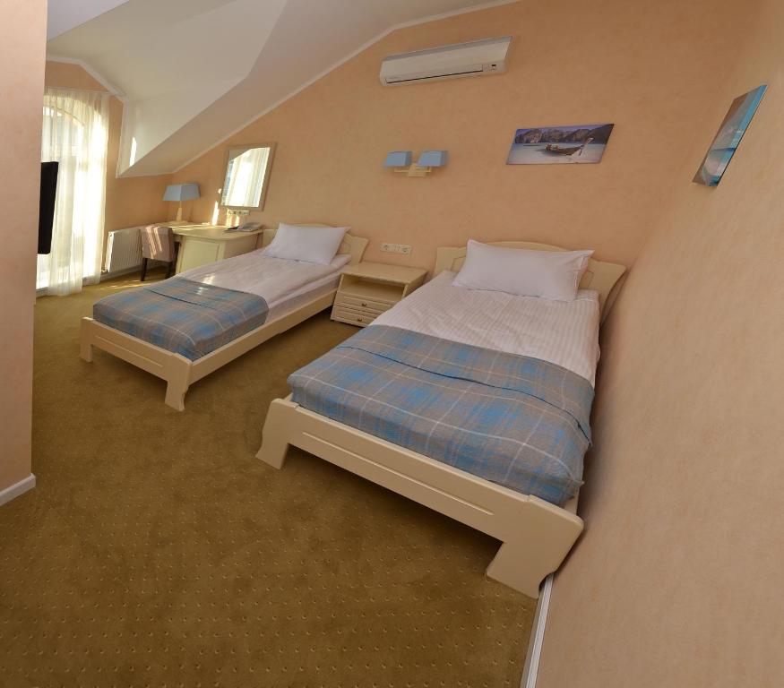 Postel nebo postele na pokoji v ubytování Hotel Ajur