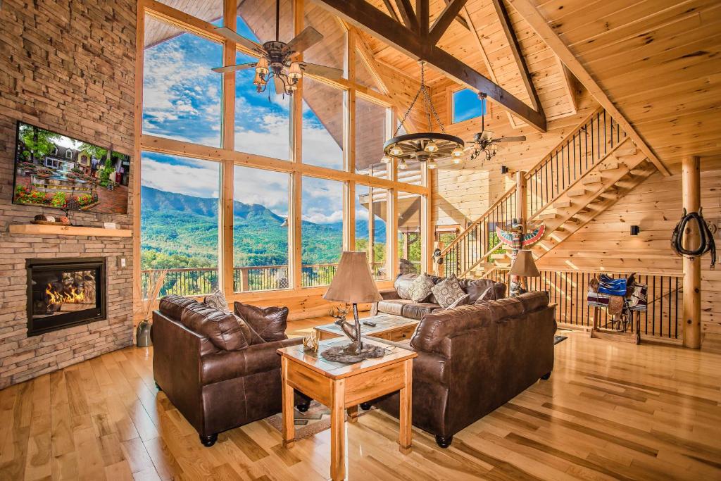 a living room with leather furniture and a fireplace at Star Dancer Cabin in Gatlinburg