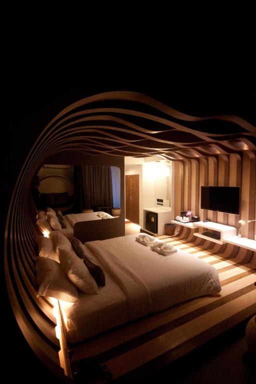 Postel nebo postele na pokoji v ubytování Nimman Mai Design Hotel Chiang Mai