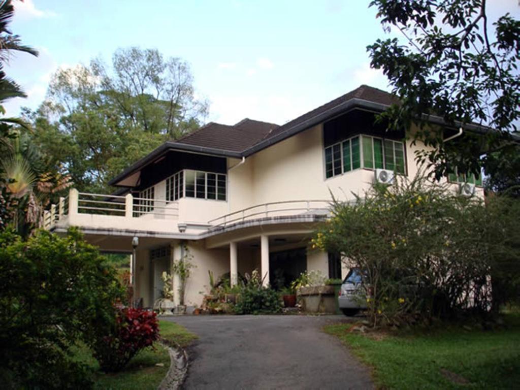 a house with a car parked in front of it at The Fairview Guesthouse in Kuching