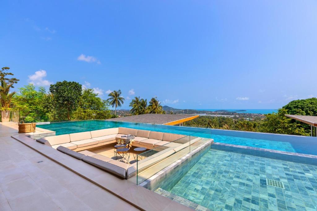 a swimming pool with a table in the middle at Asi Chaweng 6 BR sea view in Koh Samui 