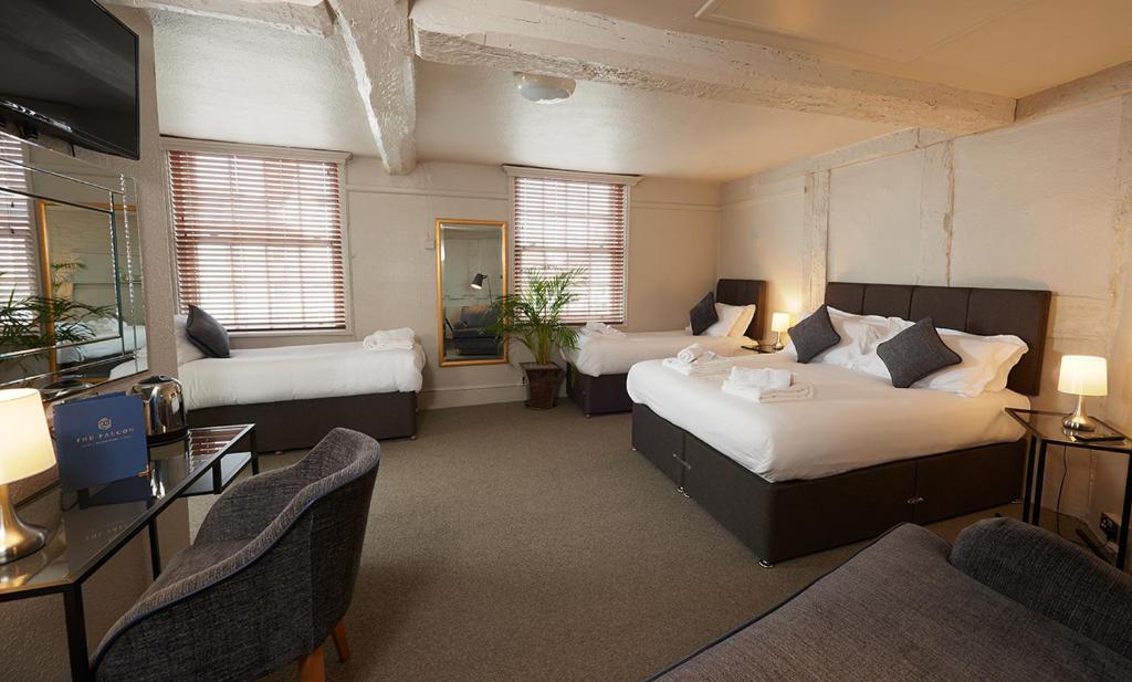 a hotel room with two beds and a television at The Falcon Hotel in Bridgnorth