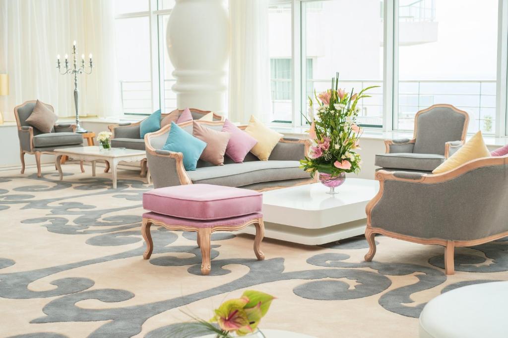 a living room with a couch and chairs at Hotel Farah Tanger in Tangier