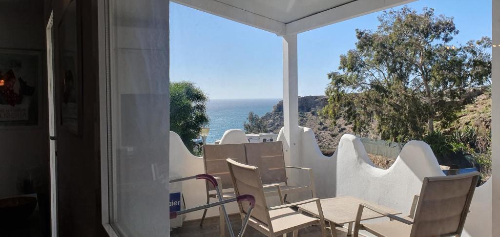 a view of the ocean from the balcony of a house at La cueva inès in Almería