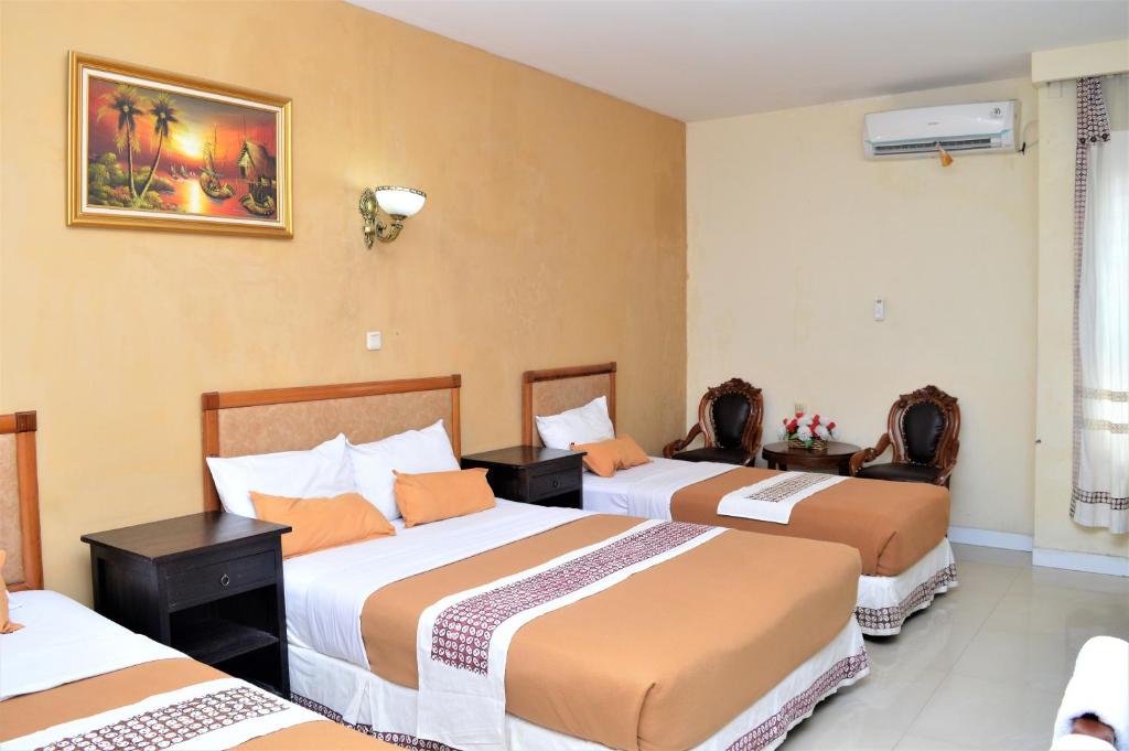 Postel nebo postele na pokoji v ubytování Hotel Mataram 2 Malioboro