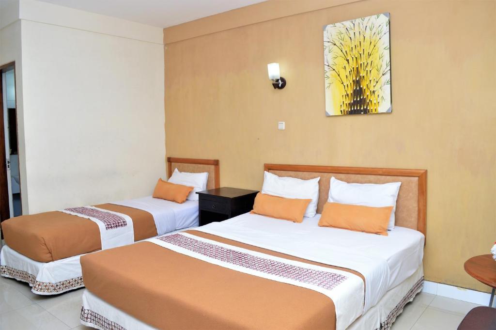Postel nebo postele na pokoji v ubytování Hotel Mataram 2 Malioboro
