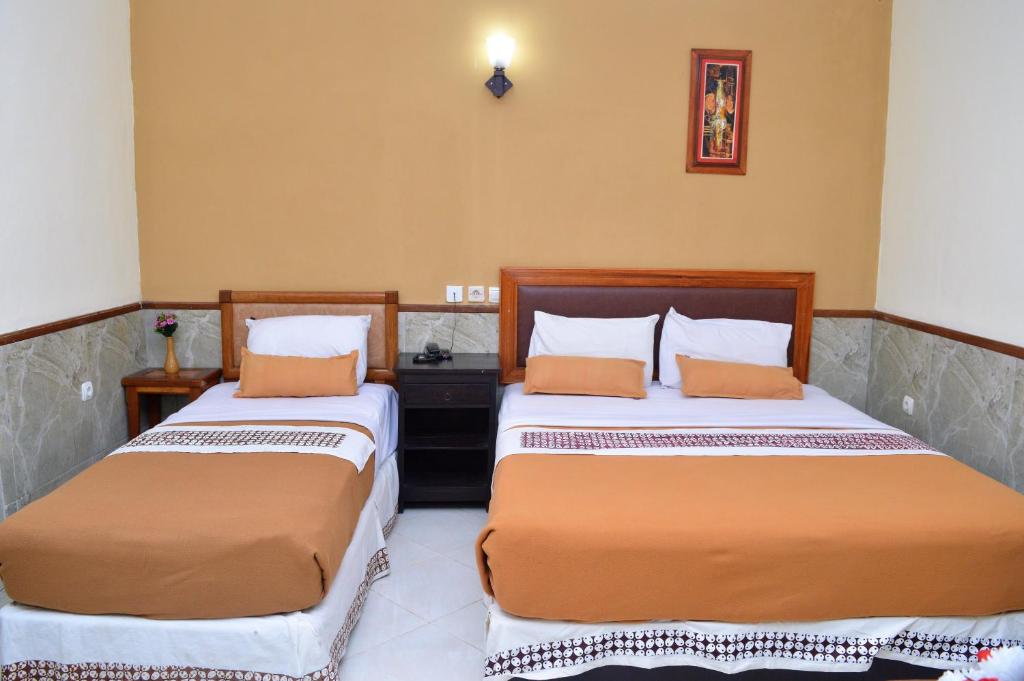 Postel nebo postele na pokoji v ubytování Hotel Mataram 2 Malioboro
