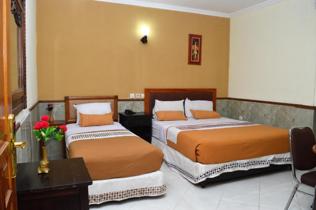 Postel nebo postele na pokoji v ubytování Hotel Mataram 2 Malioboro