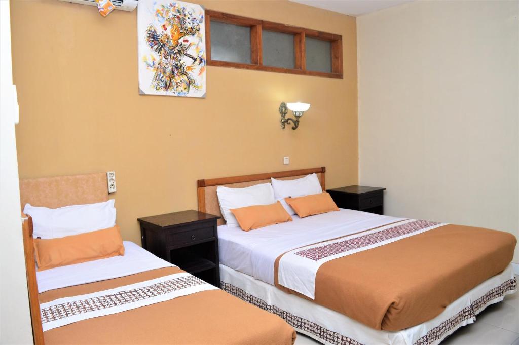 Postel nebo postele na pokoji v ubytování Hotel Mataram 2 Malioboro