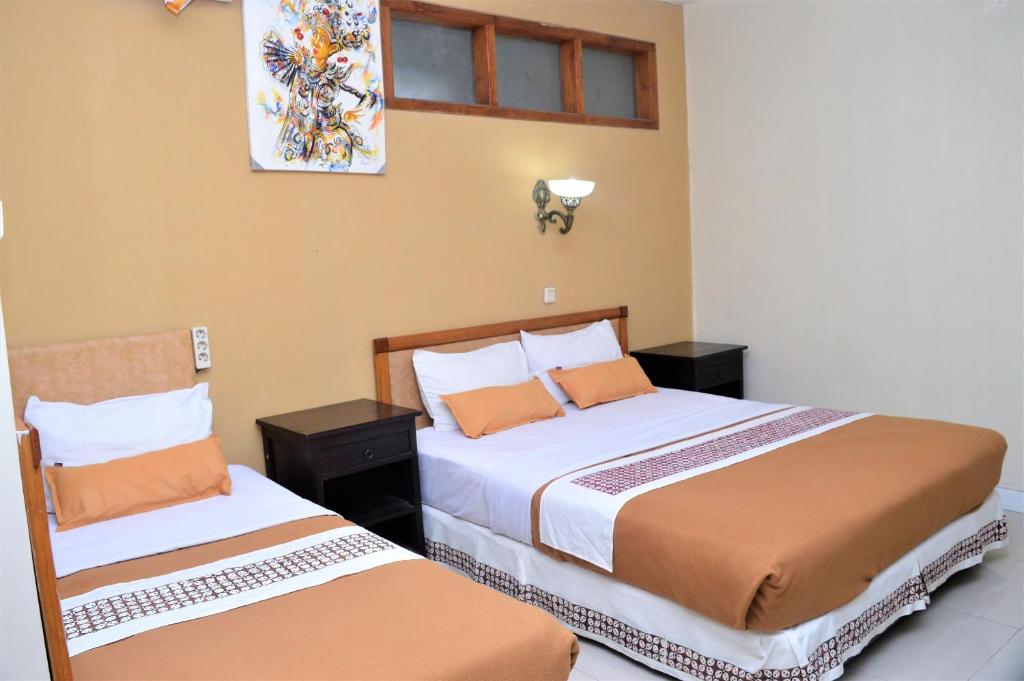 Postel nebo postele na pokoji v ubytování Hotel Mataram 2 Malioboro