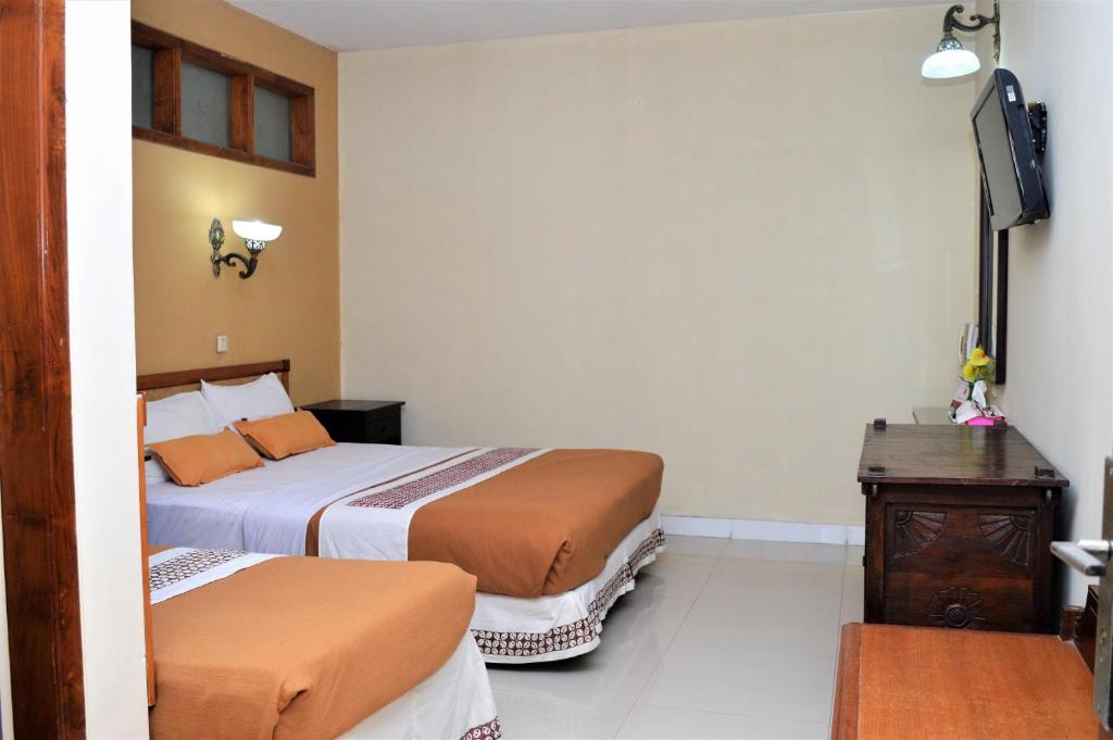 Postel nebo postele na pokoji v ubytování Hotel Mataram 2 Malioboro