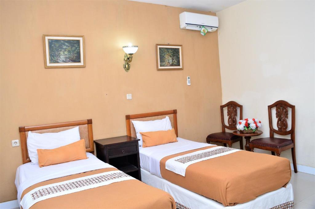 Postel nebo postele na pokoji v ubytování Hotel Mataram 2 Malioboro
