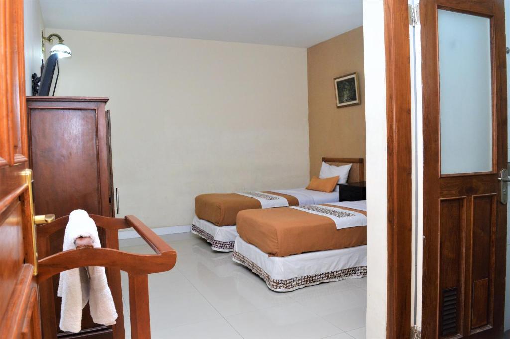 Postel nebo postele na pokoji v ubytování Hotel Mataram 2 Malioboro