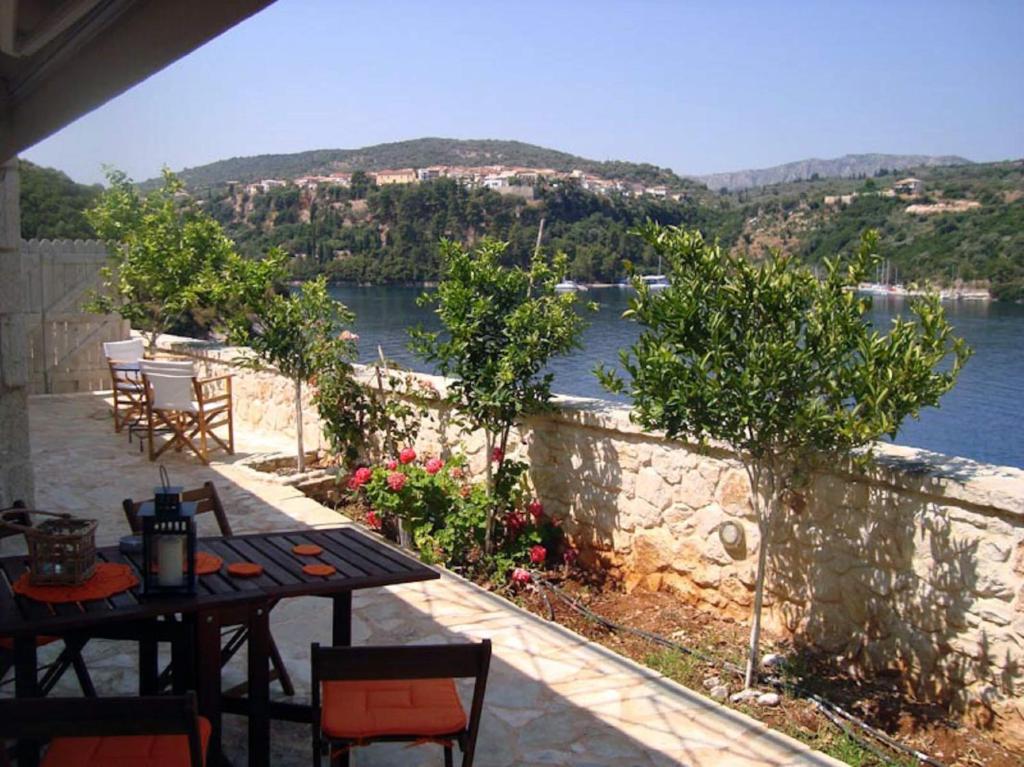 a table and chairs with a view of the water at Meganisi Blue apartment in Meganisi