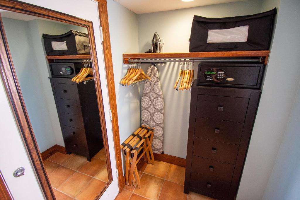 a bedroom with a mirror and a closet at Vanderbilt Beach Resort in Naples