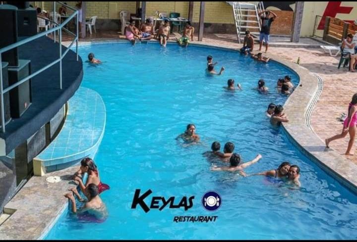 a group of people swimming in a swimming pool at Keylas Hotel in Ica