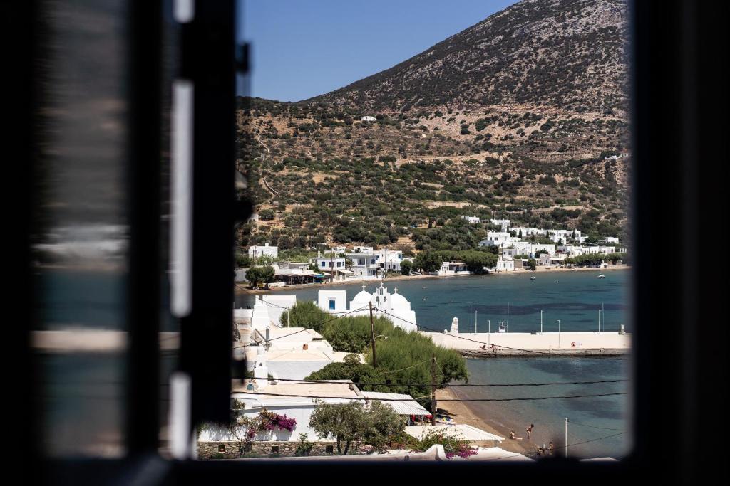 una ventana con vistas a una ciudad y a una playa en SifnosLiving A2, en Vathi