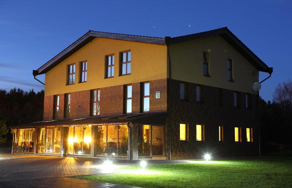 a large building with lights in front of it at Greta in Druskininkai