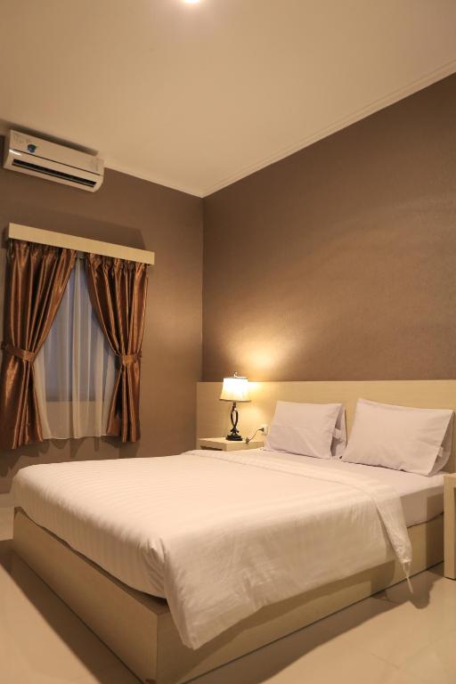 Postel nebo postele na pokoji v ubytování Hotel 55