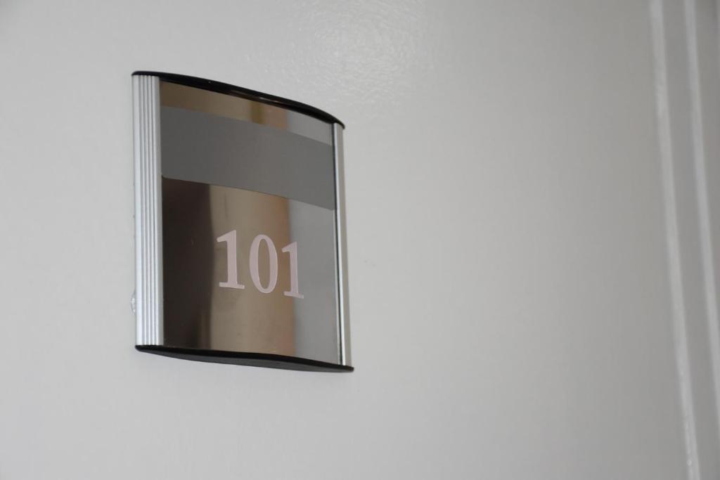 a mirror with the number on it on a wall at Exit Labirint Centar in Novi Sad
