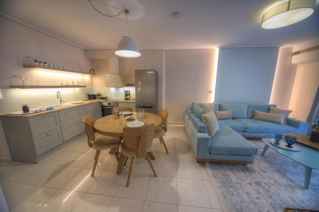 a living room with a table and a blue couch at Onar Modern Luxury Apartments in Kavala