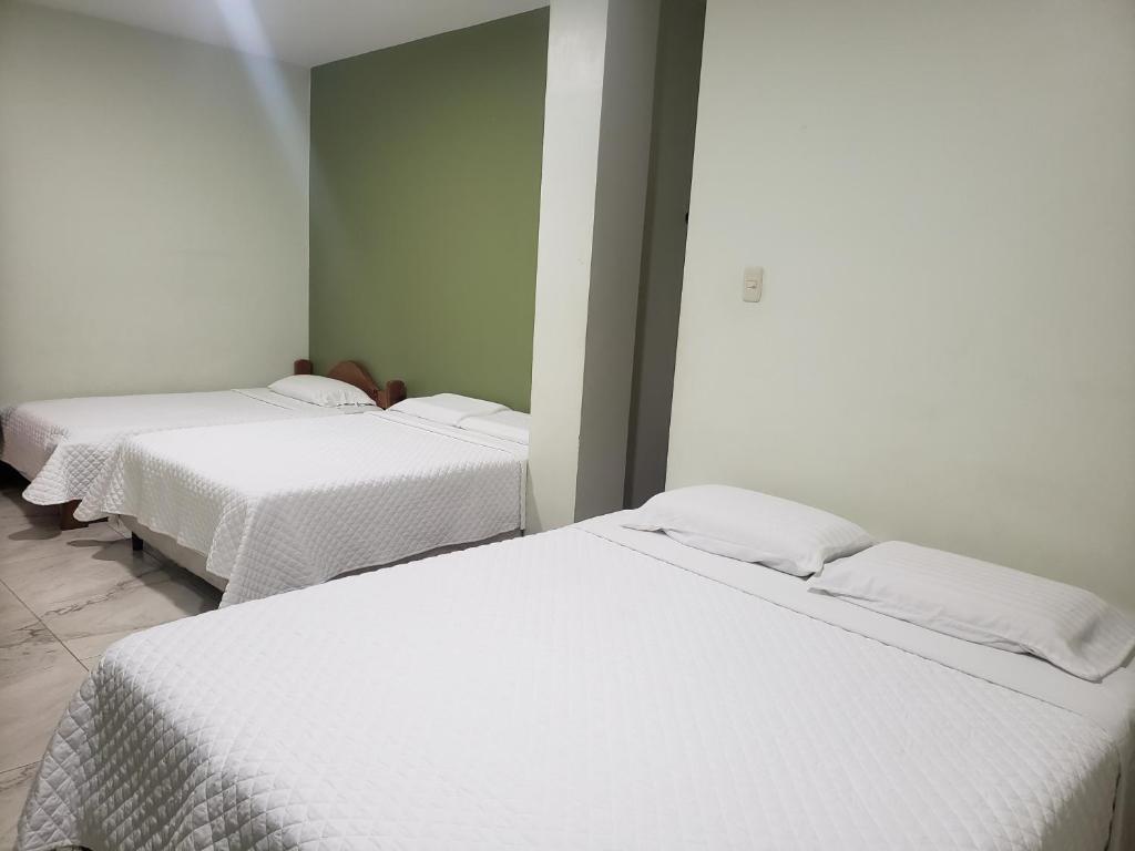 Postel nebo postele na pokoji v ubytování DC Suites Aeropuerto