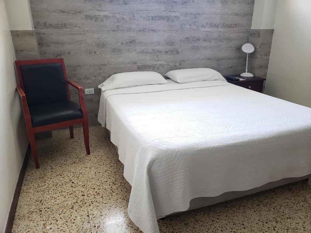 Postel nebo postele na pokoji v ubytování DC Suites Aeropuerto