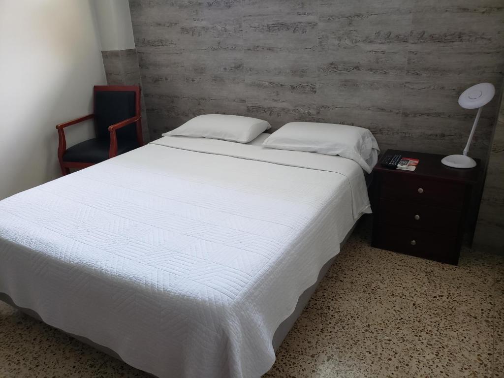 Postel nebo postele na pokoji v ubytování DC Suites Aeropuerto