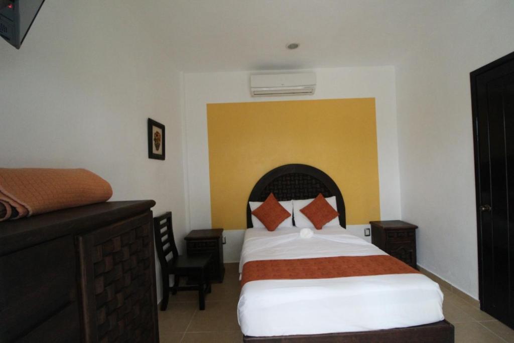 Una cama o camas en una habitación de Hotel Mexico Lindo