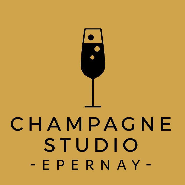 a label for a champagne studio agency with a wine glass at Champagne Studio in Épernay