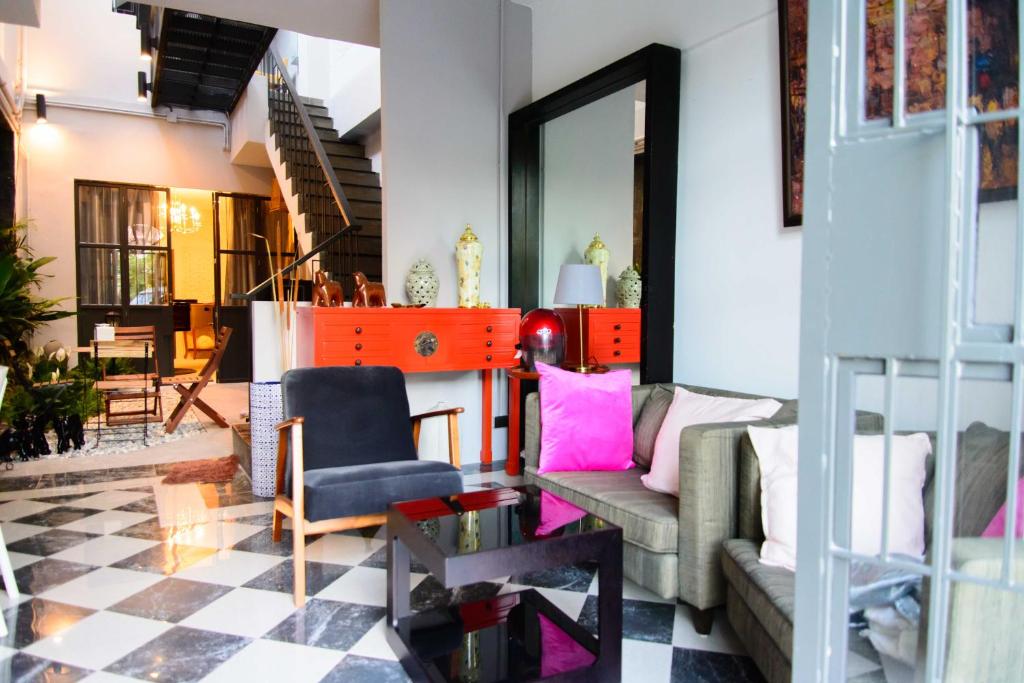 a living room with a couch and a chair at 87 Oldtown at River Pier in Bangkok