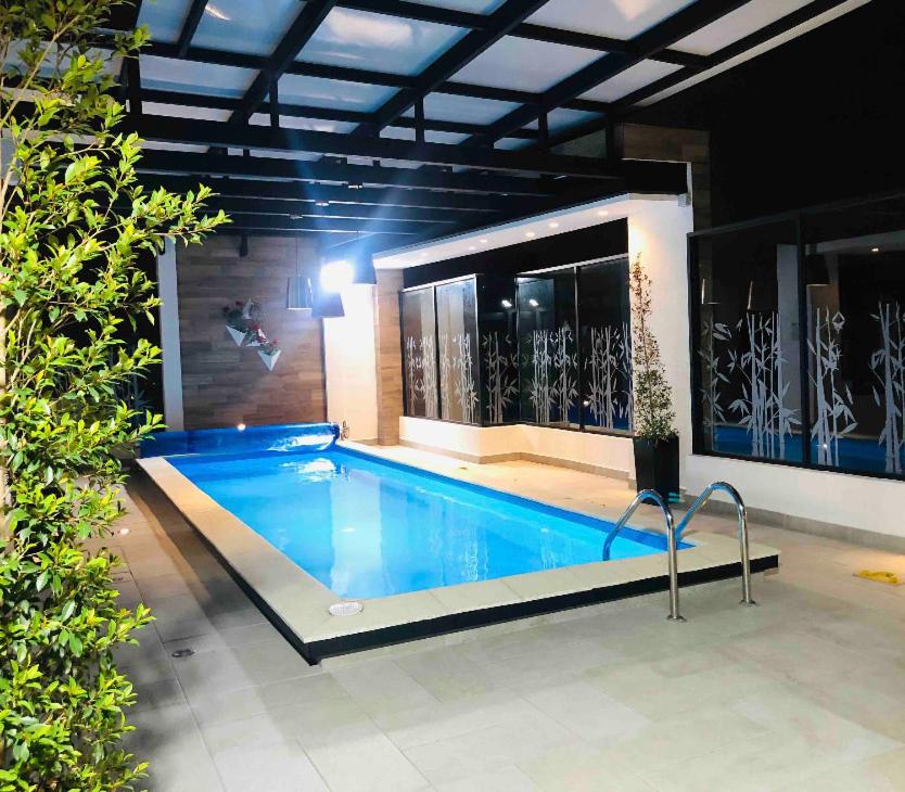 una piscina con una persona saltando en ella en Jacuzzi Piscina Sauna Turco Suite Lujosa, en Quito