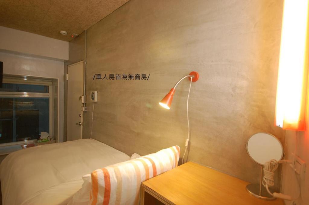 Postel nebo postele na pokoji v ubytování 墾丁橘月Orange Moon Inn