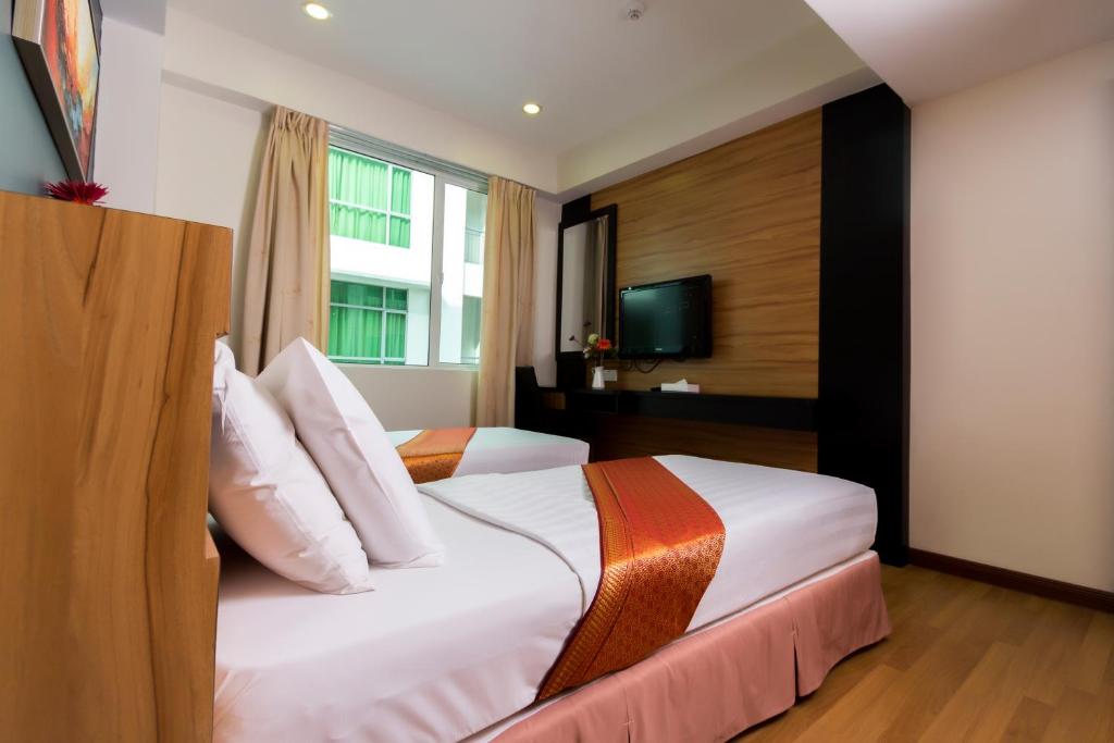 Postel nebo postele na pokoji v ubytování Mariner Hotel Labuan