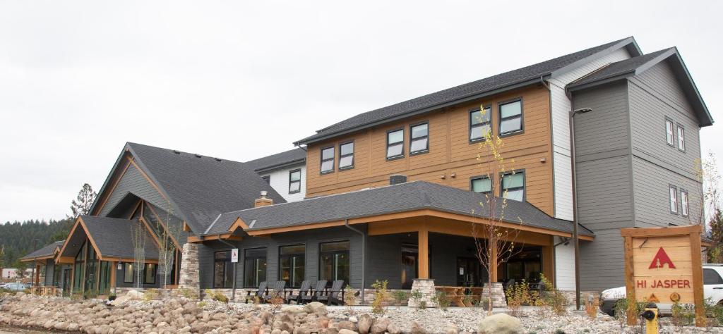 a large house with a wooden at HI Jasper - Hostel in Jasper