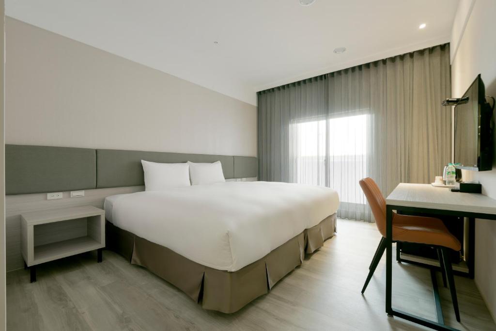 Postel nebo postele na pokoji v ubytování Fengjia JinRui Hotel