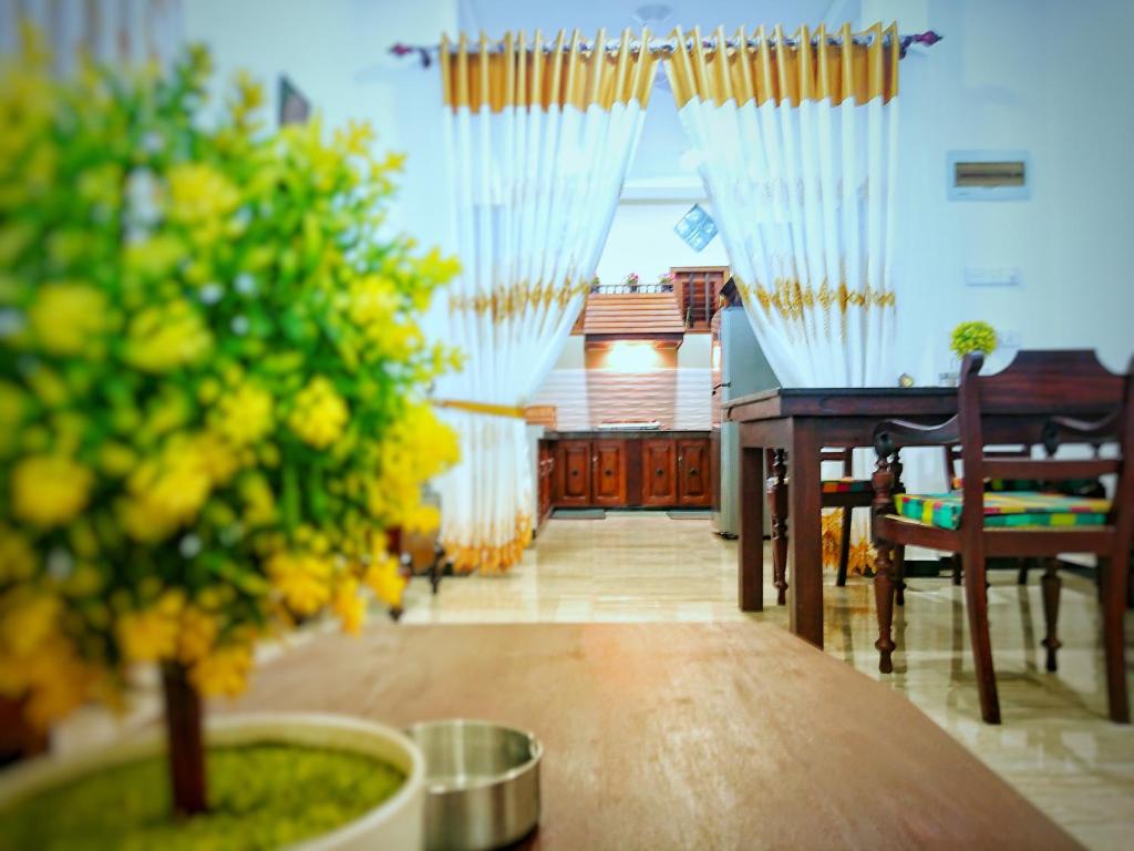a view of a dining room with a table and a tree at Halcyon Rest in Hikkaduwa